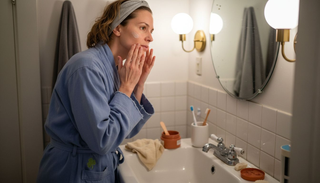 Woman applying moisturizer during nighttime skincare